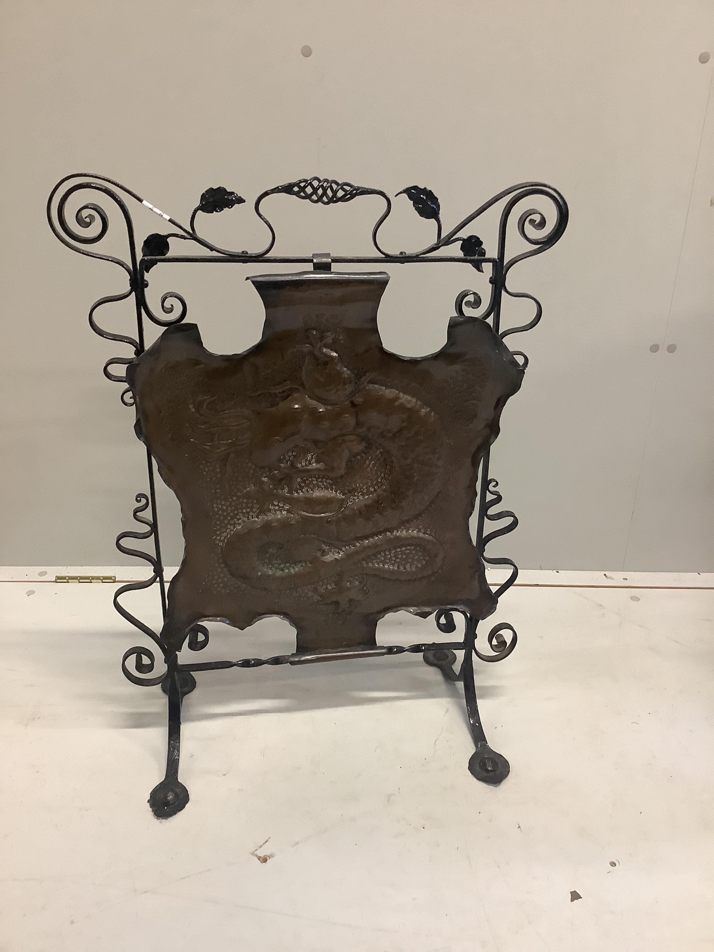 An Edwardian embossed copper and wrought iron fire screen, height 79cm